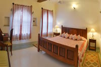 Burj Suite with carved stone arches and low seating, Castle Bijaipur, Bijaipur