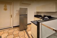 Shared guest kitchenette with star-patterned stone floor, Diwan House, Agra