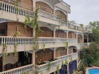 Bougainvillea-draped balconies above the pool, Jas Vilas, Jaipur