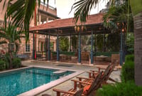 Lounge pool and chandelier-lit garden gazebo at dusk, Niravi, Jaipur