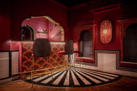 Bar stools on a striped marble floor in the red bar lounge, Padmaa, Jaipur