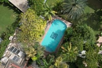 Aerial view of the crest-tiled swimming pool amid palms and gardens, Ranbanka Palace, Jodhpur