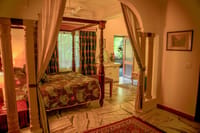 Luxury Suite bedroom with four-poster bed and marble floor, Ranbanka Palace, Jodhpur
