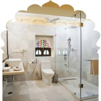 Marble bathroom with walk-in shower and coloured-glass jharokha window, Rawla Narlai, Narlai