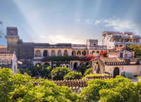 Crenellated rooftops, arched balconies and bougainvillea of the 17th-century retreat, Rawla Narlai, Narlai