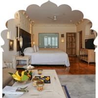 Narlai Suite bedroom with carved headboard, lanterns and parquet floor, Rawla Narlai, Narlai