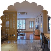 Suite living area behind a carved jali screen with village views, Rawla Narlai, Narlai