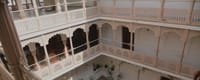 Tiered courtyard balconies with carved arches and lattice screens, Talabgaon Castle, Talabgaon
