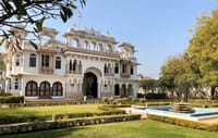 White castle facade with domed pavilions, lawns and fountain pool, Talabgaon Castle, Talabgaon