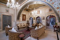 Chandelier-lit lounge with mirrored ceiling work