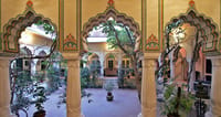 Scalloped arches around a planted inner courtyard