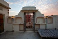 The rooftop at dusk, with its alcoves and charpoy