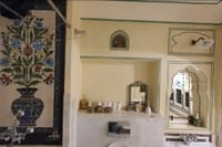 Painted floral panel above the washstand