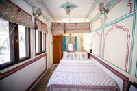 A long room lined with windows and fresco work