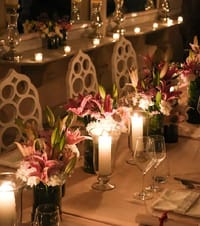 A table set with lilies and candles for dinner