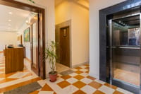 Lobby with lift and chequered floor