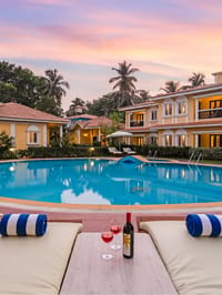 Poolside loungers facing the resort at dusk