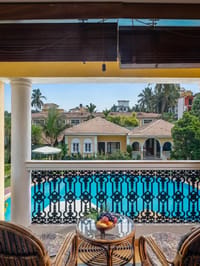 Balcony view over the pool through wrought-iron railing