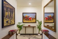 Corridor hung with framed Rajasthani paintings