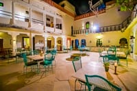 Courtyard set for evening dining under the arcades