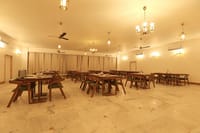 Restaurant hall with wooden tables and chandeliers
