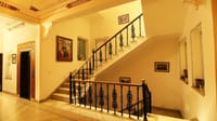 Whitewashed staircase with wrought-iron balustrade