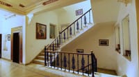Whitewashed staircase with wrought-iron balustrade
