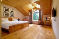 Cedar-floored room with carved ceiling at Nadis