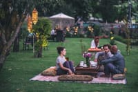 Lantern-lit dinner on the lawn at Nadis