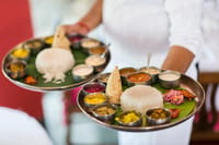 Kerala thali on a banana leaf with rice, curries and pappadam served at The Malabar House