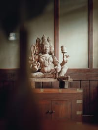 Carved wooden deity on a cupboard at Old Harbour Hotel