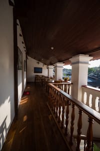 First floor veranda at The Old Courtyard Hotel with turned wooden balustrade and timber ceiling