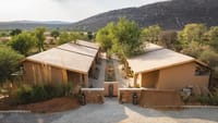 Villa roofs seen from above against bare hills