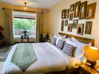 Bedroom hung with framed miniature paintings