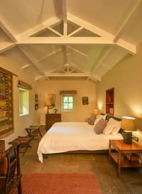 Bedroom under a white pitched truss ceiling