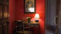 Writing desk against a deep red wall