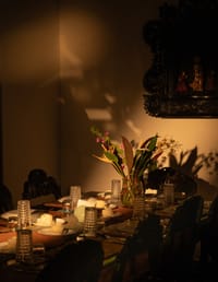 Dining table laid with candles and flowers