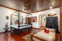 Vermillion suite with four-poster bed and red floor