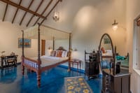 Aqua room with four-poster bed and blue floor