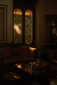 Backlit stained glass doors in a sitting room