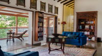 Reading room with bookcase and blue sofa