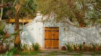 Timber garden door in a white boundary wall