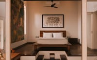 Heritage room with low bed and framed artwork