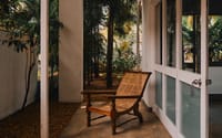 Planter's chair on a verandah beside the garden