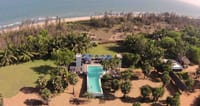 Swimming pool and lawn seen from above the beach