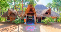 Thatched entrance pavilion with kolam on the ground