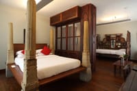 Karaikudi Suite with carved timber and stone columns