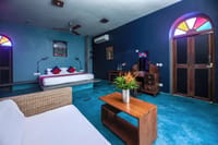 Garden Suite bedroom with blue walls and stained glass