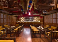 Bar with timber floor and birdcages