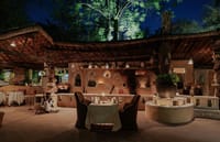 Mud-walled Dhani restaurant lit at night